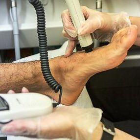 A podiatrist treating a patient's foot problem