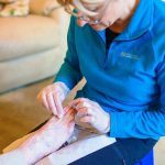 Judith Cowling Podiatrist caring for a patient with a foot problem