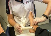 Judith Cowling Podiatrist treating a patient for musculoskeletal problems