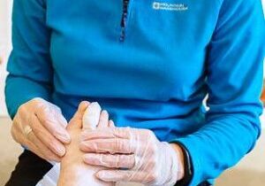 A podiatrist treating a patient with corns